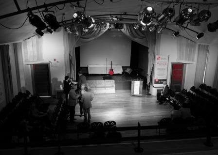 black and white image of an empty theatre stage