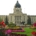 SK Legislative building behind a yard of flowerbeds and a grass walkway