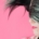 a woman with her hair draped over the top half of her face is earing pig headphones on a pink background