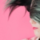 a woman with her hair draped over the top half of her face is earing pig headphones on a pink background