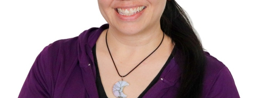 Headshot of Jennifer, a metis woman with her black hair tied at the nape of her neck. She is wearing a purple shirt and a crescent moon necklace.