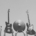 grey image of multiple instrument being held up into the frame by multiple people