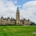 Canadian Parliament against a cloudy blue sky.