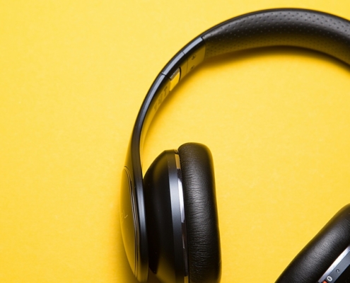 Black headphones on a bright yellow background