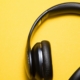 Black headphones on a bright yellow background