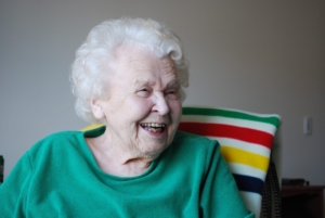 Senior woman, Thelma Pepper, white haired and smiling. She is looking off to the right
