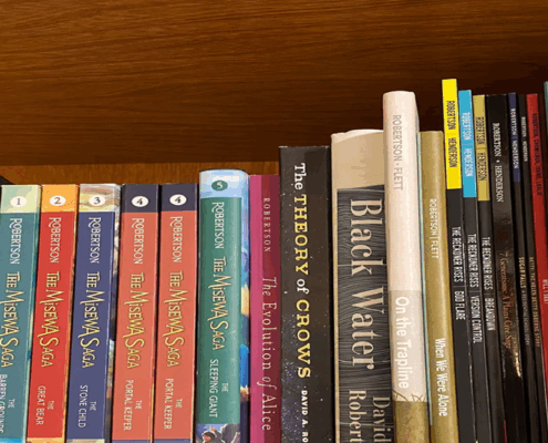colour photo of books on a shelf, all by Canadian author David Robertson
