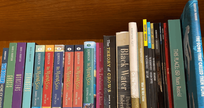 colour photo of books on a shelf, all by Canadian author David Robertson