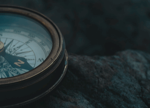 Compass laying on rocks