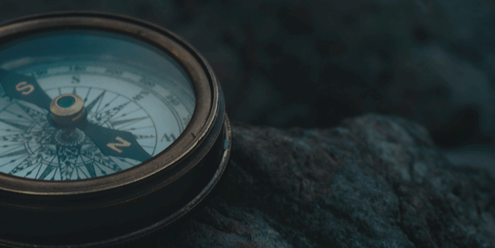 Compass laying on rocks
