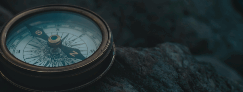 Compass laying on rocks