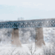 Saskatoon bridge on a cold and crisp day. Light blue sky and mist coming up from the snowy ground