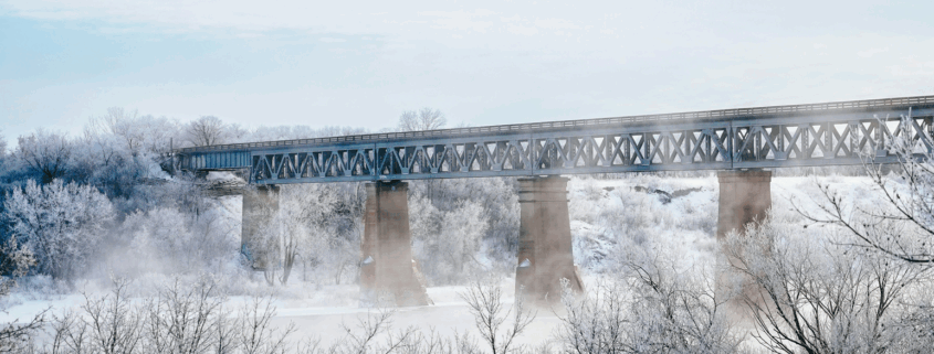 Saskatoon bridge on a cold and crisp day. Light blue sky and mist coming up from the snowy ground