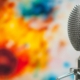 Metal double sided microphone in the foreground with a blurred painting in the background