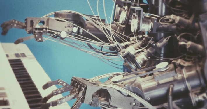 Metal robot playing a keyboard