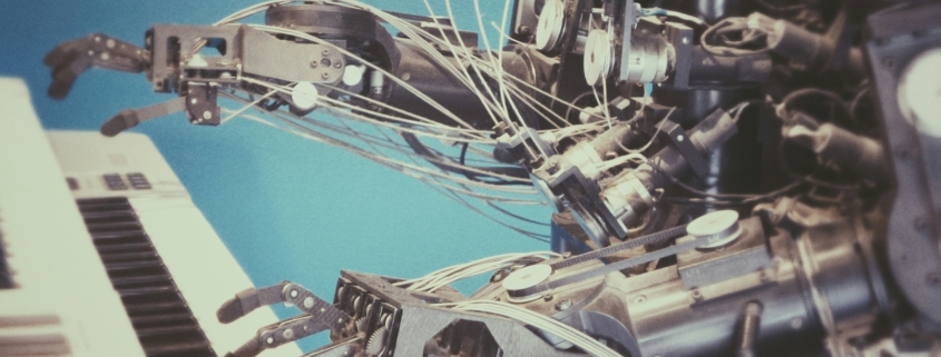 Metal robot playing a keyboard