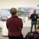 Jason Baerg speaking to a group of visitors during a curatorial talk inside the Mann Art Gallery.