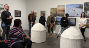 Two suspended, dome-shaped papier-mâché sculptures by Soheila Fallah hang slightly above the gallery floor. The pale, textured forms hover in the space, inviting close listening as they emit subtle soundscapes and spoken Persian poetry.