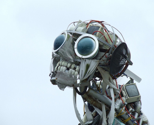 Sculpture of a robotic with human teeth and large black glass eyes