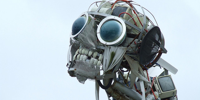 Sculpture of a robotic with human teeth and large black glass eyes
