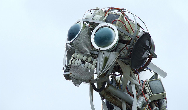 Sculpture of a robotic with human teeth and large black glass eyes