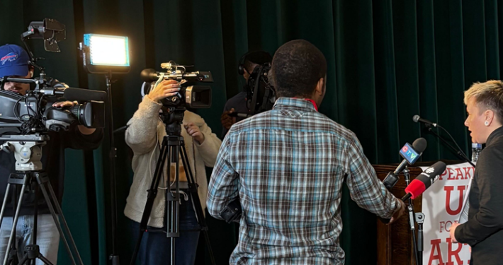 SAA Executive Director, Em Ironstar, speaking to the press who are filming her