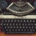 picture of a typewriter, in between a cup of black coffee, a smart phone, and a screenwriting book
